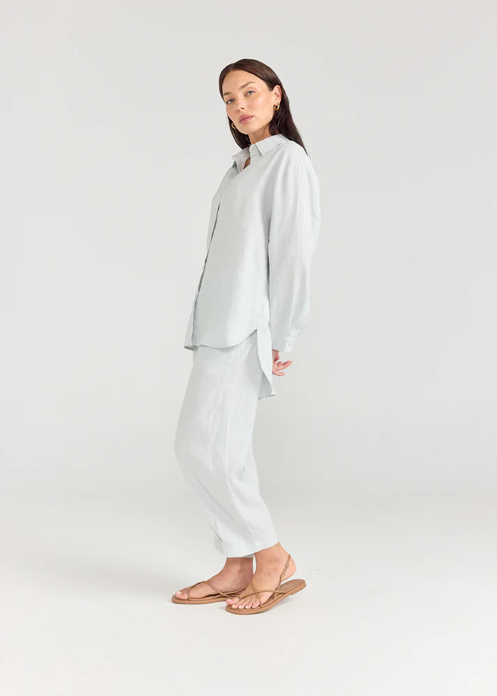 Woman wearing a light gray outfit on a white background