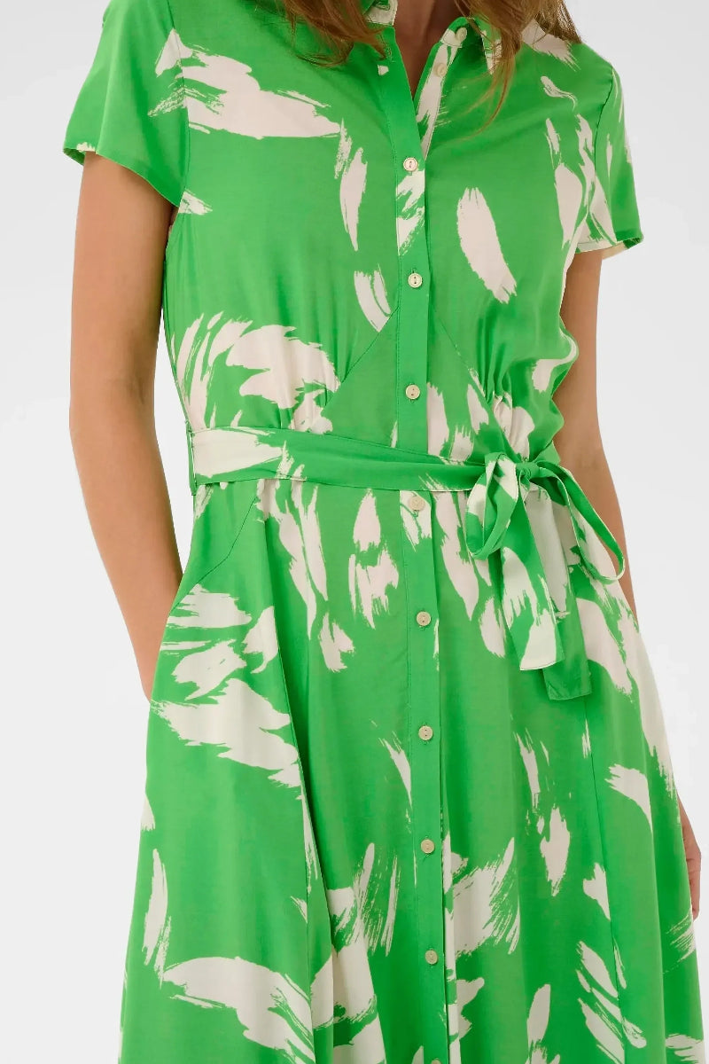 Green dress with white floral pattern on a white background