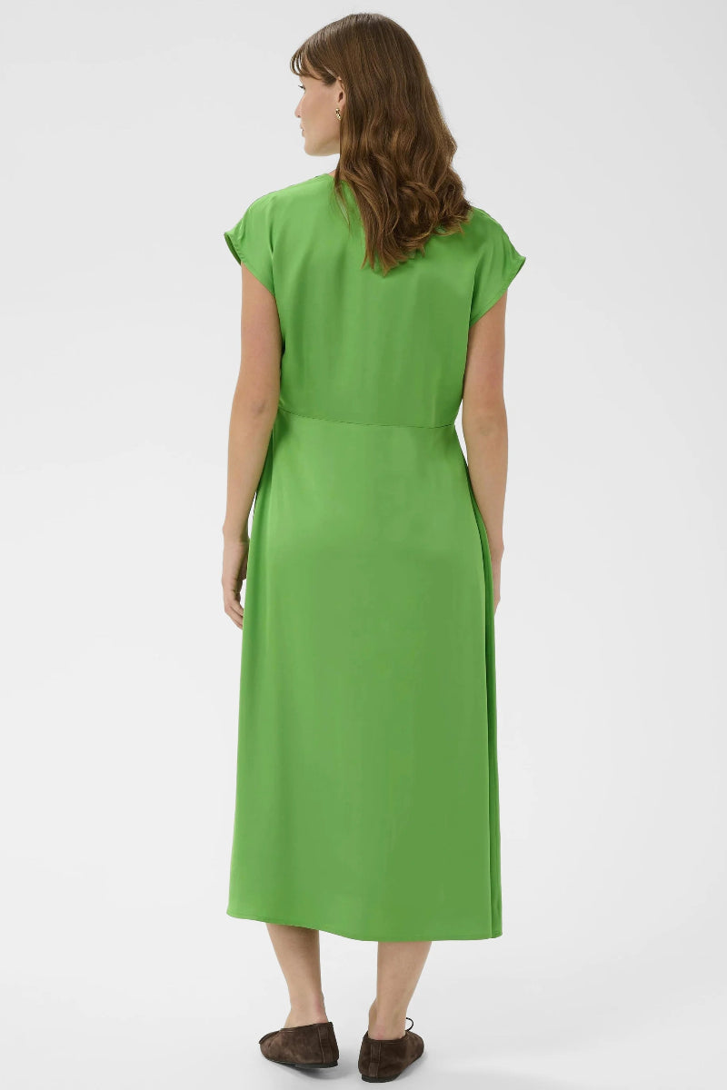 Woman wearing a green dress on a white background