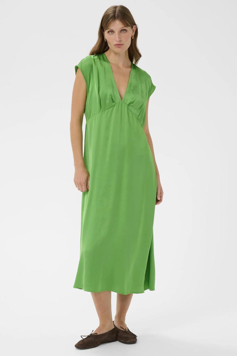 Woman wearing a green dress on a white background