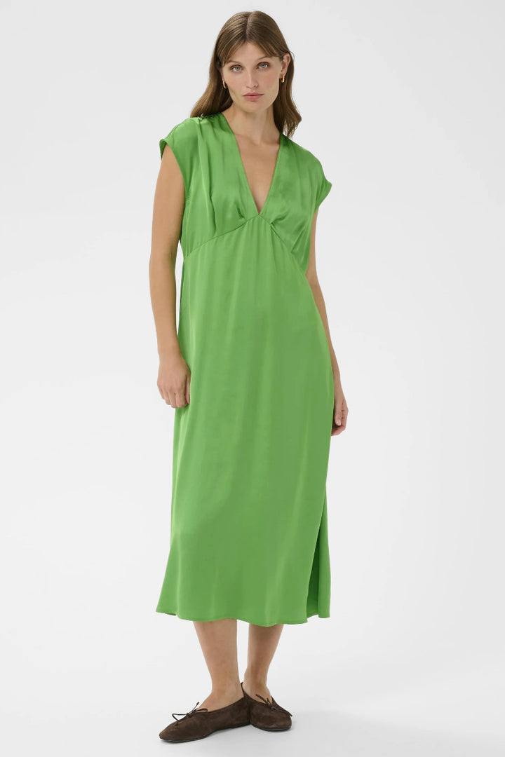 Woman wearing a green dress on a white background
