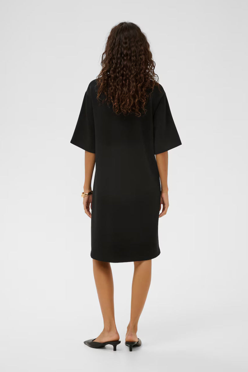 Person wearing a black dress from behind on a white background