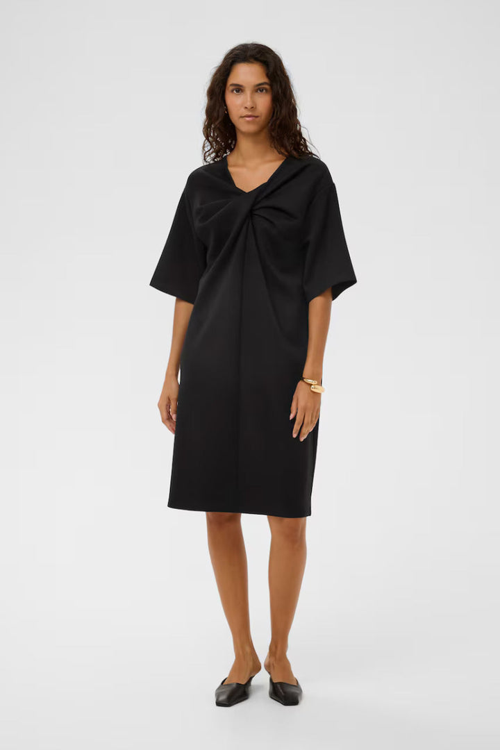 Woman wearing a black dress on a white background