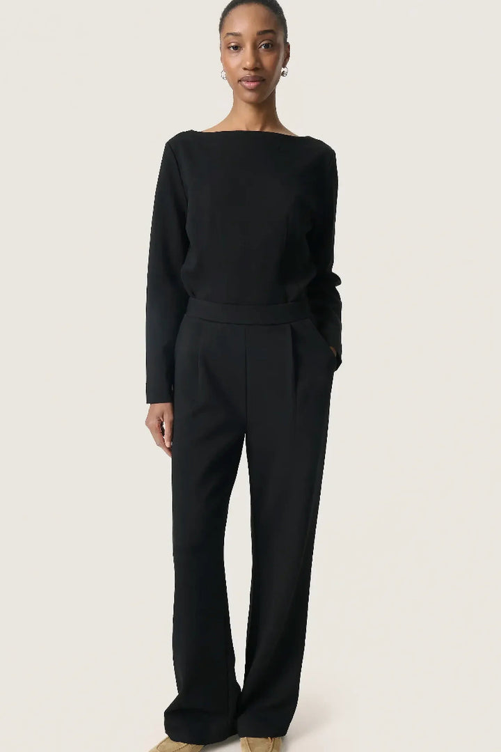 Person wearing a black outfit on a white background