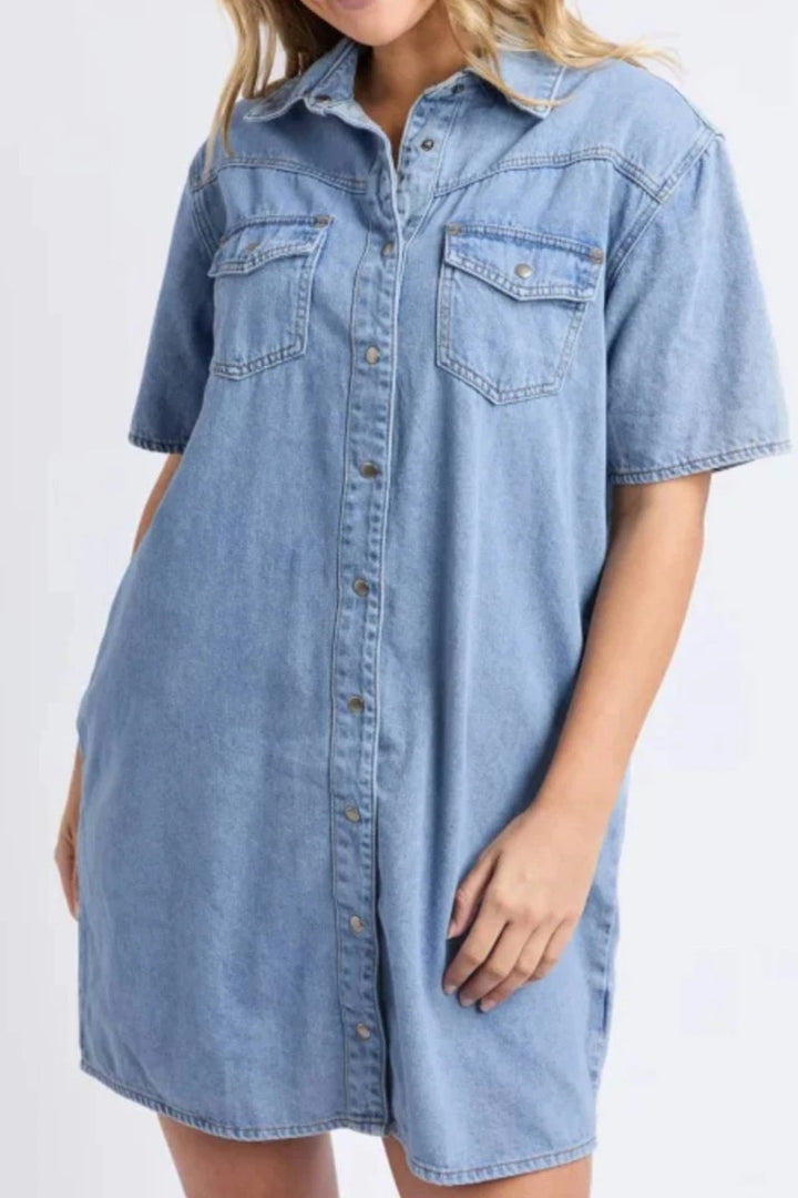 Denim shirt dress worn by a person on a white background