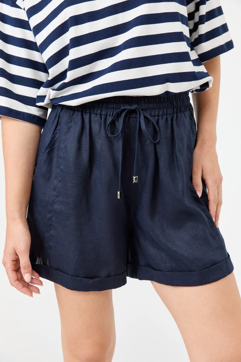 Person wearing navy shorts and a striped shirt on a white background