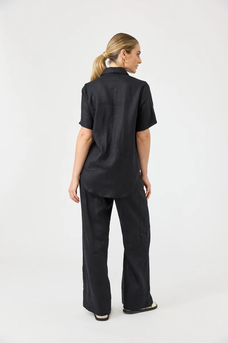 Person wearing a black outfit on a white background