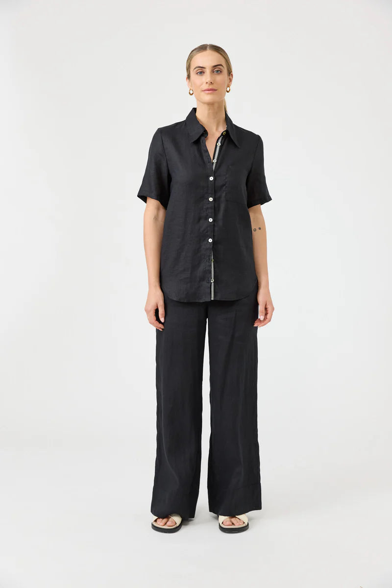 Woman wearing a black outfit on a white background
