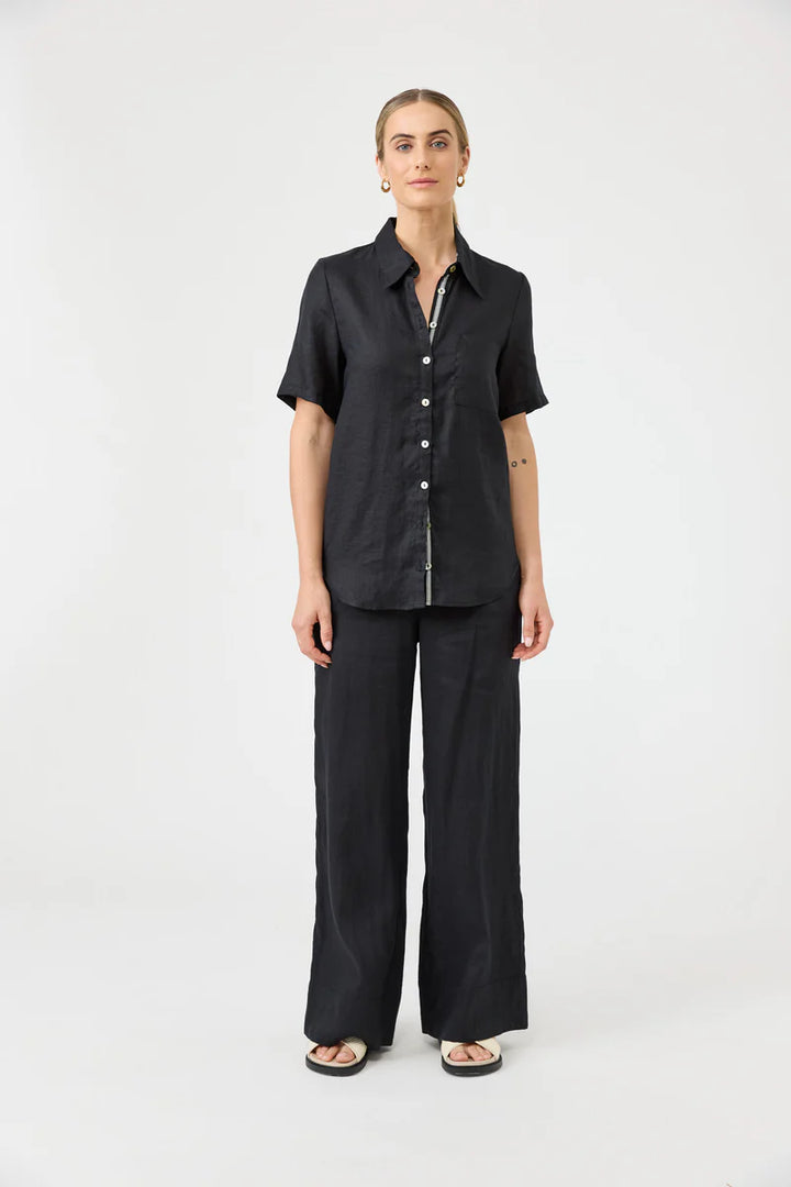 Woman wearing a black outfit on a white background