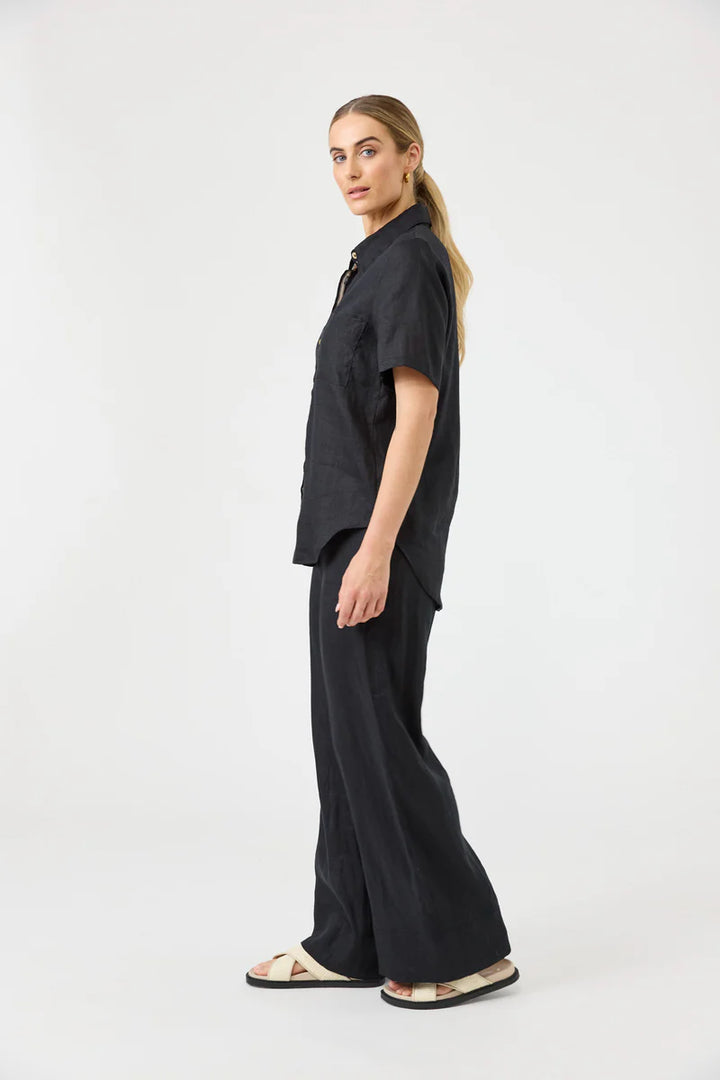 Woman wearing a black outfit on a white background