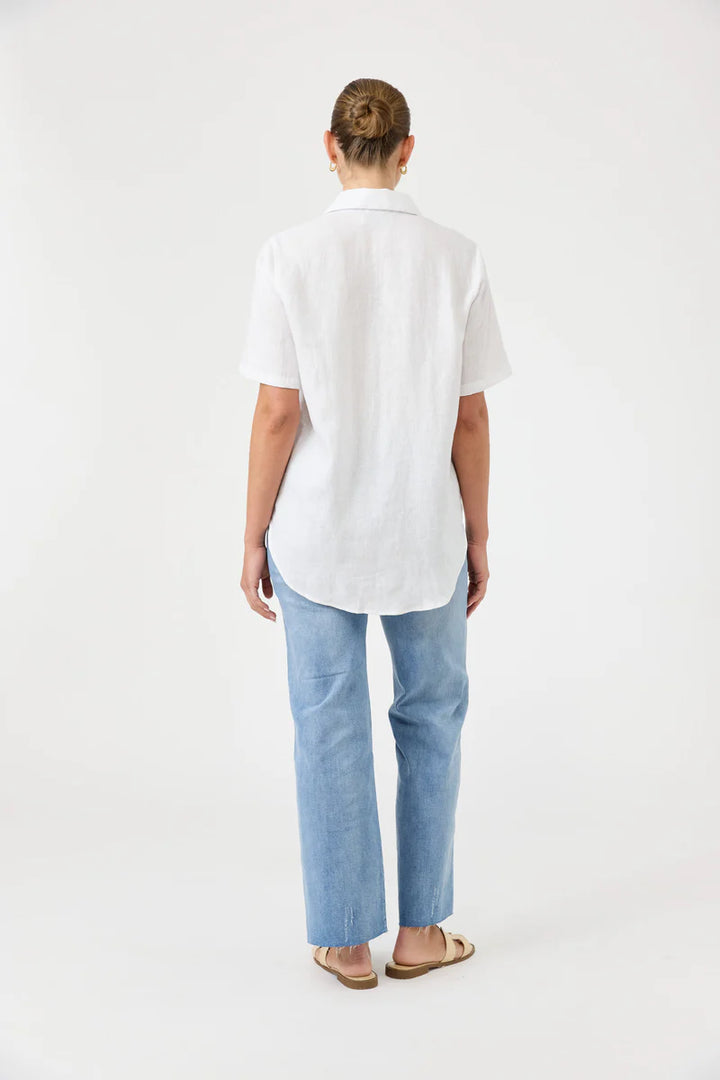 Person wearing a white shirt and light blue jeans on a white background