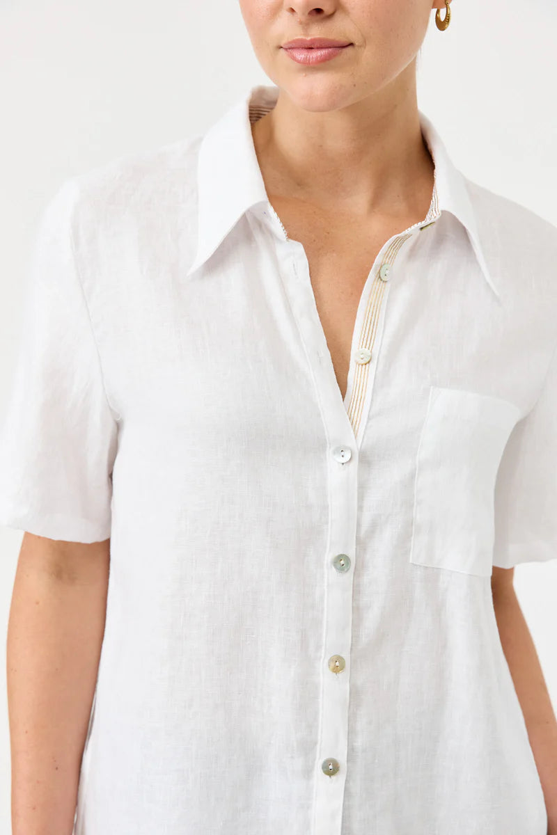 White button-up shirt worn by a person on a white background