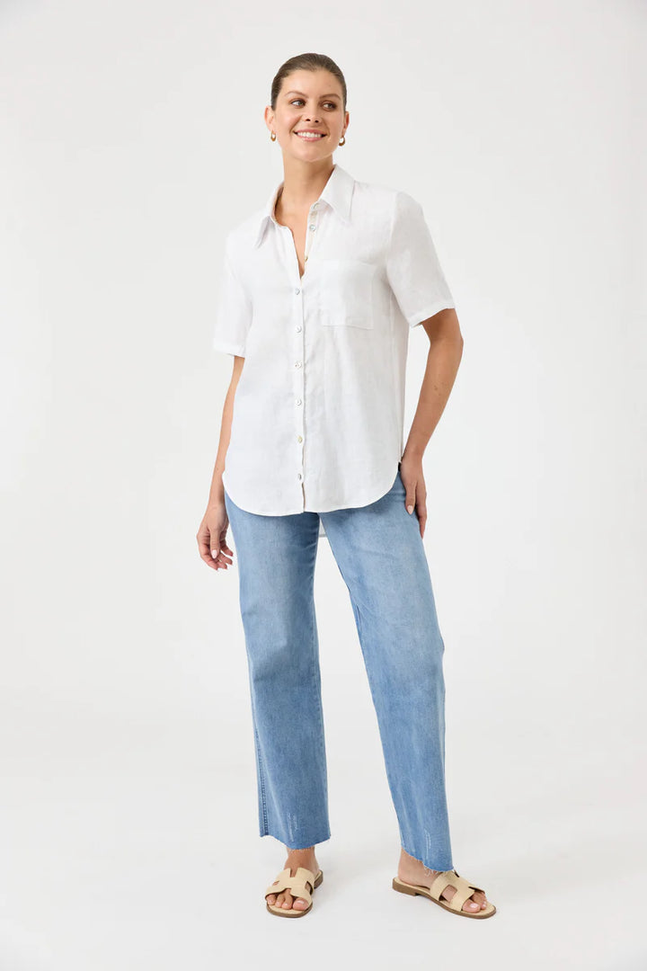 Woman wearing a white shirt and light blue jeans on a white background