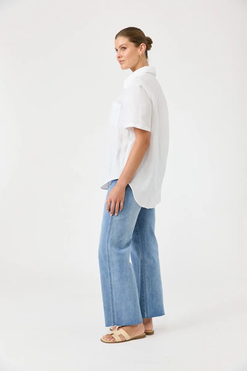 Person wearing a white shirt and blue jeans on a white background