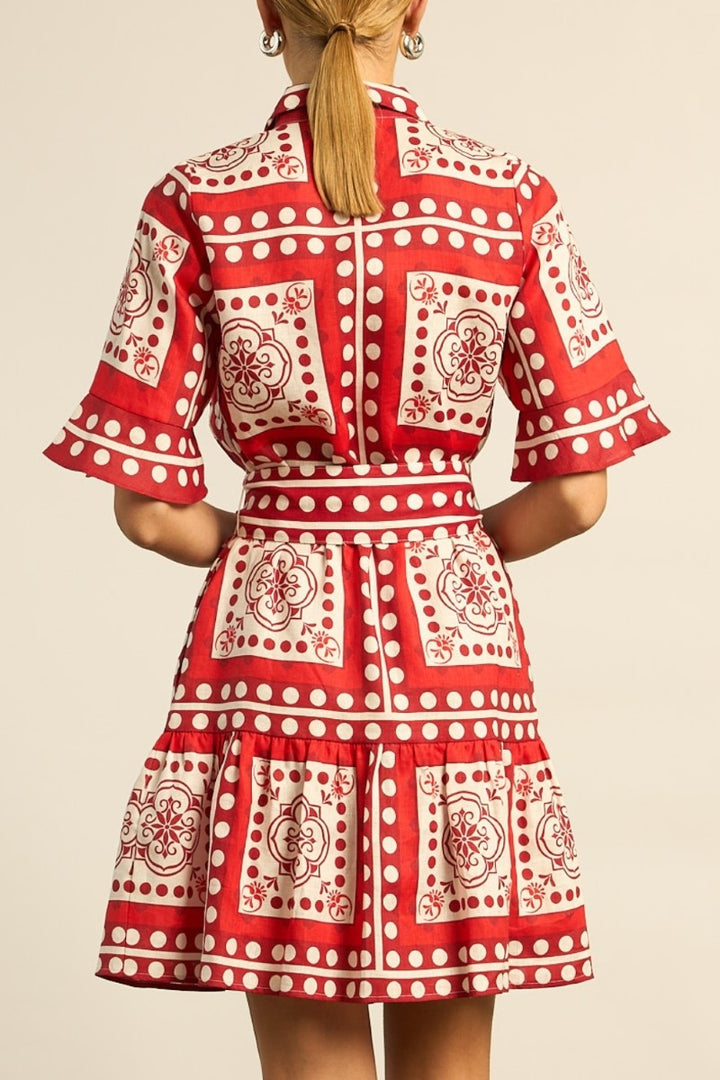 Red and white patterned dress on a plain background