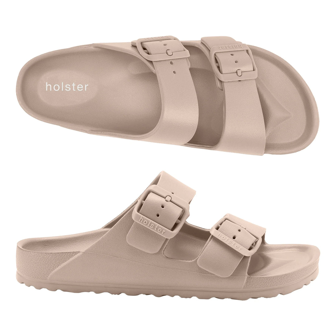 Front view of the Sundreamer Slide in beige, featuring a wide strap design and minimalist silhouette on a flat sole.