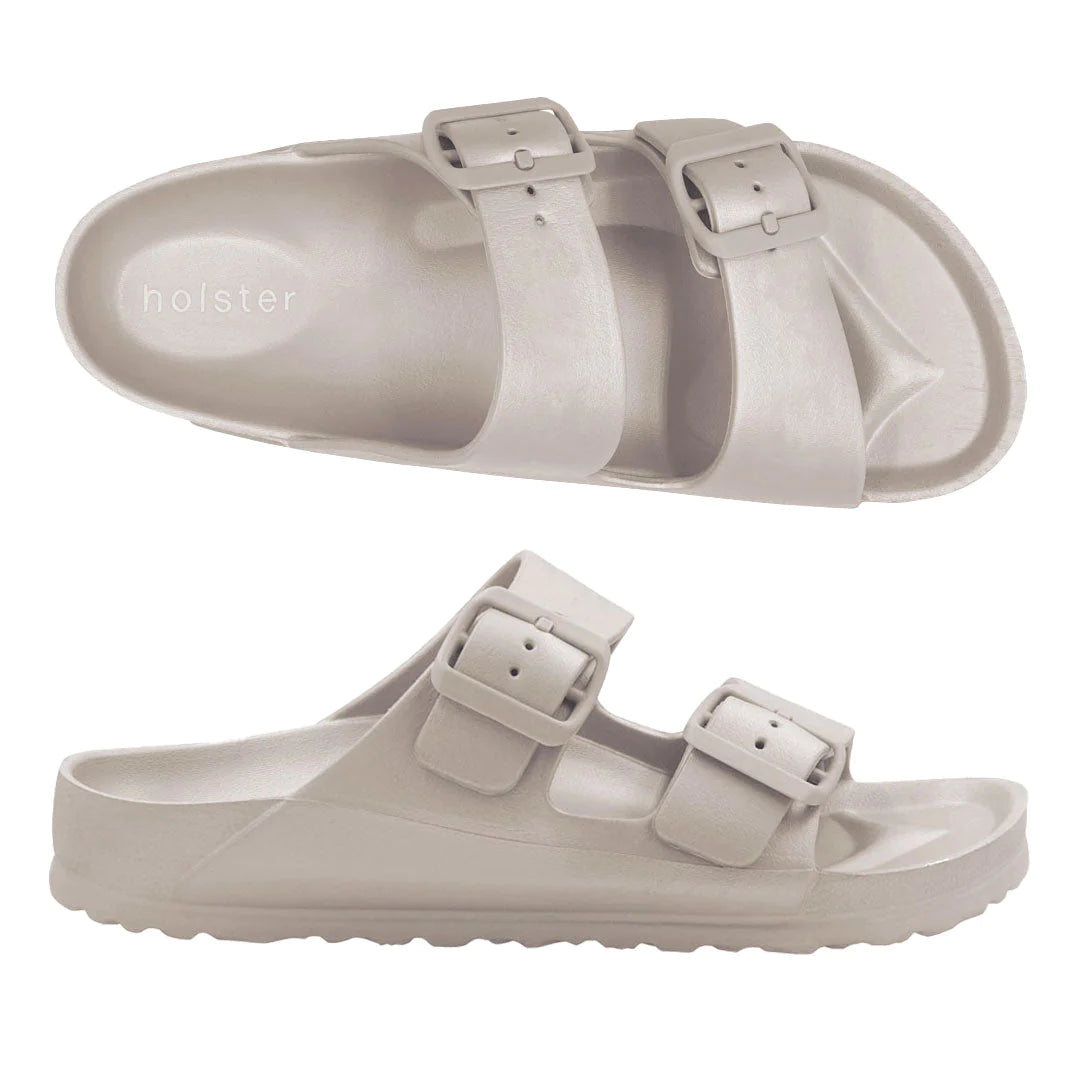 Front view of the Sundreamer Slide in sand color, featuring a wide strap and flat sole with a clean, minimalist design.