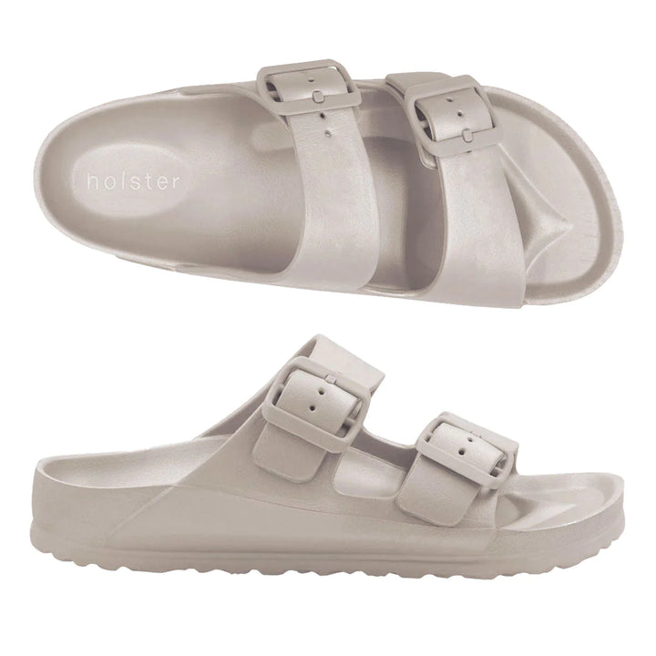 Front view of the Sundreamer Slide in sand color, featuring a wide strap and flat sole with a clean, minimalist design.