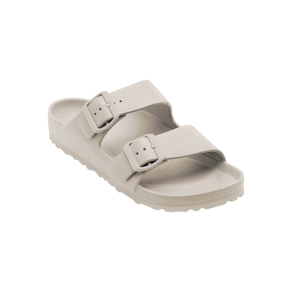 Side view of the Sundreamer Slide in sand color, showcasing the wide strap and flat sole with a sleek, minimalist profile.
