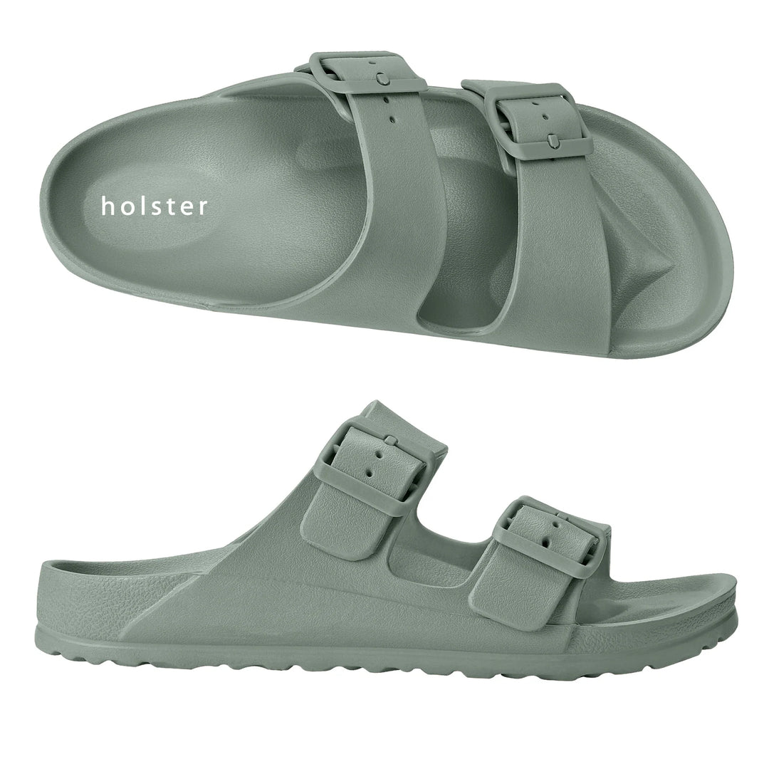 Front view of the Sundreamer Slide in seagrass green, featuring a wide strap and flat sole with a clean, minimalist design.