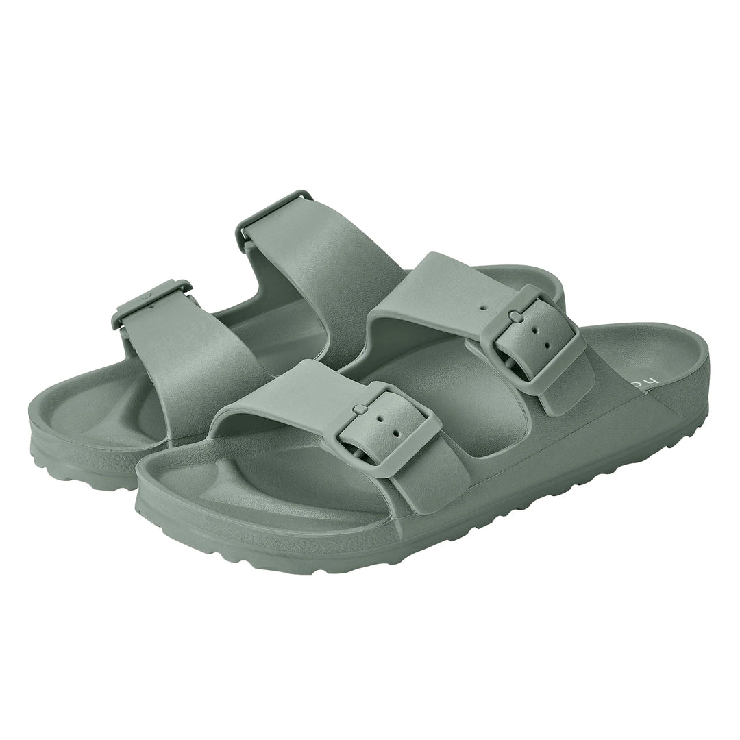 Alternate side view of the Sundreamer Slide in seagrass green, highlighting the clean lines, wide strap, and flat sole.