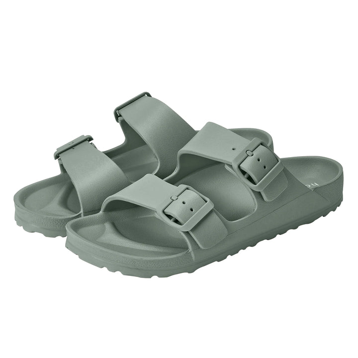 Alternate side view of the Sundreamer Slide in seagrass green, highlighting the clean lines, wide strap, and flat sole.