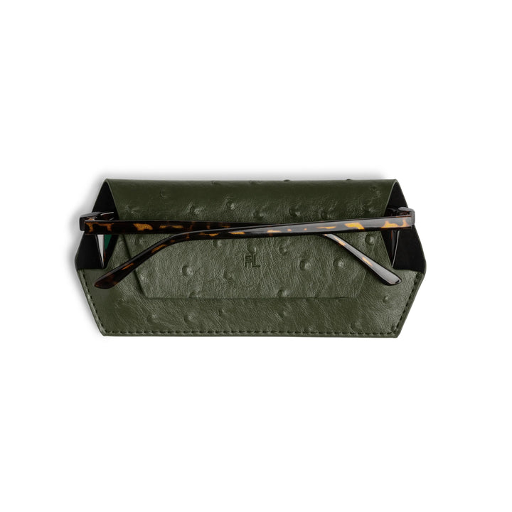 Green glasses case with tortoiseshell-framed glasses on a white background