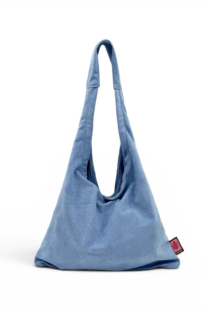 Blue denim bag with a visible brand label on a white background