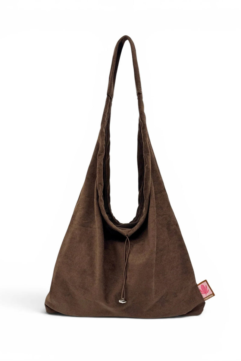 Brown suede handbag on a white background