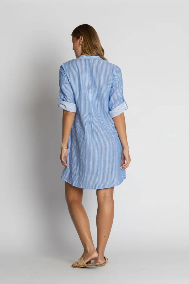 Woman wearing a blue striped dress against a white background