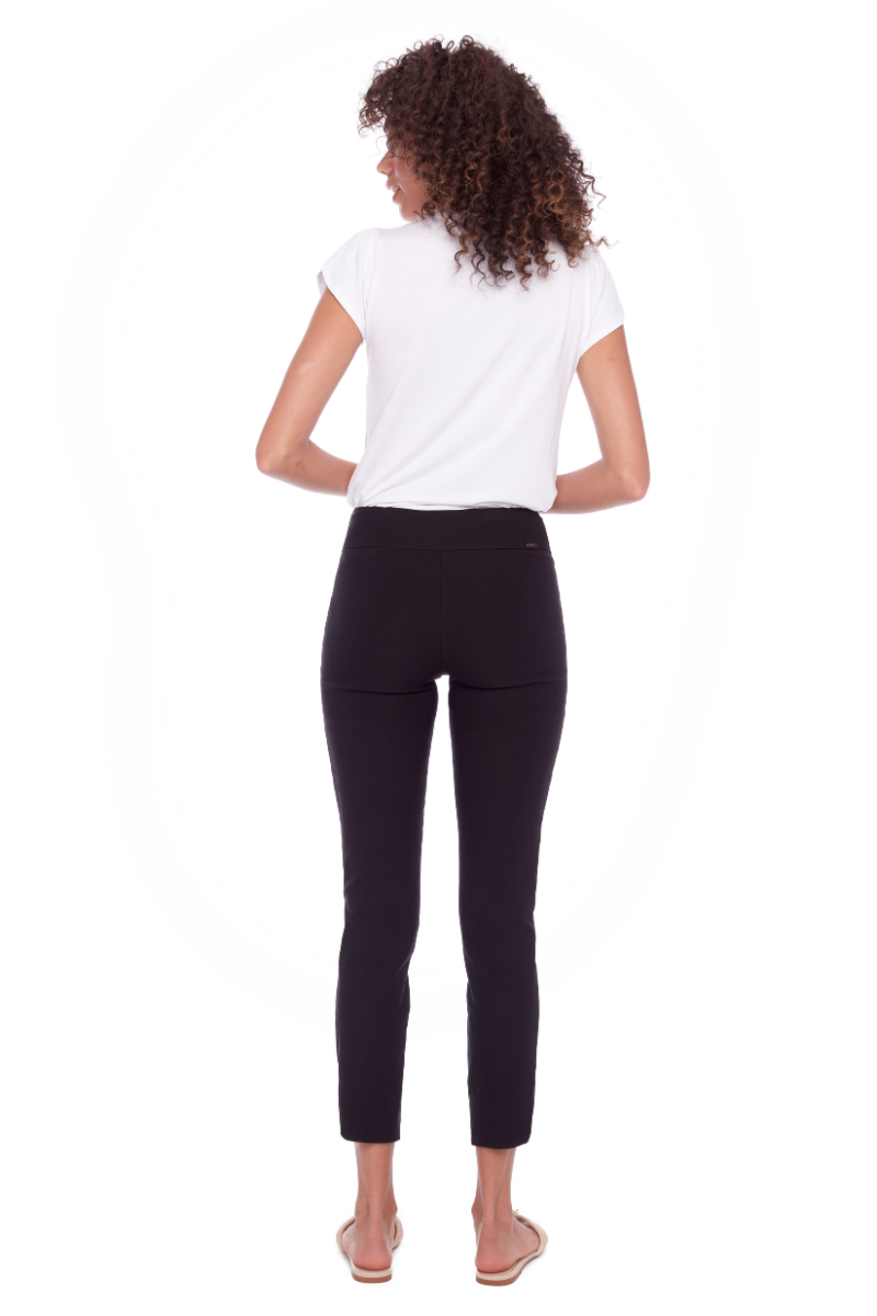 Woman wearing a white t-shirt and black leggings on a white background