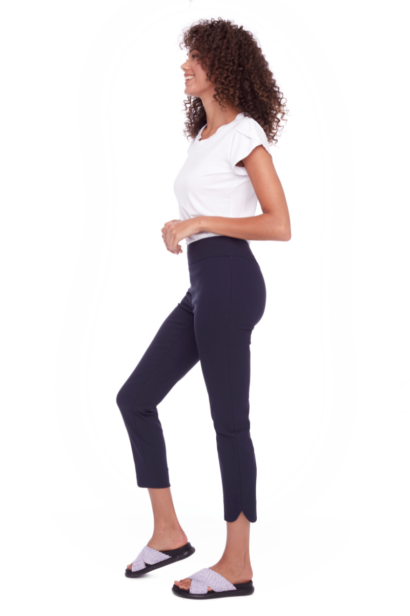 Woman wearing a white t-shirt and dark blue pants on a white background