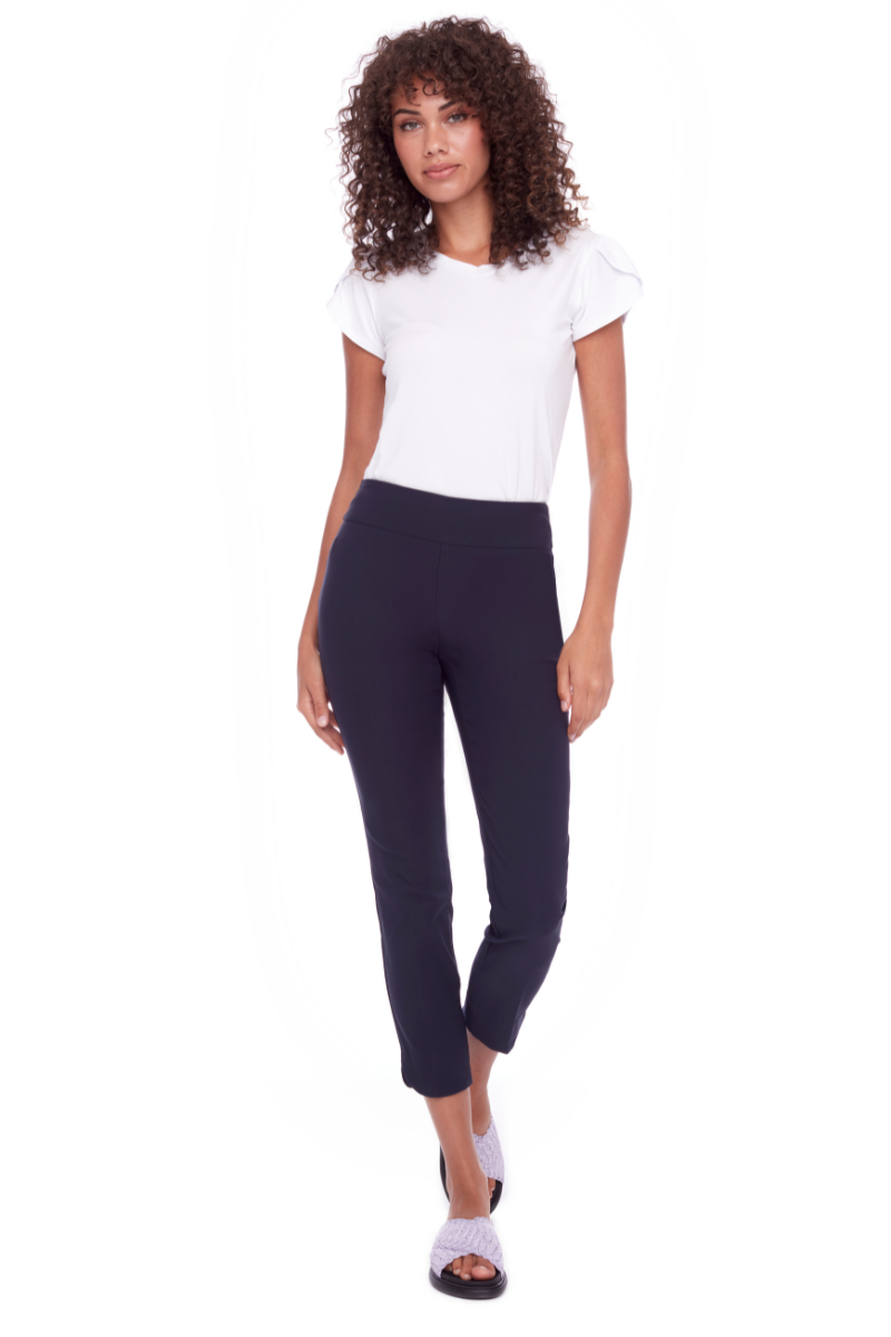 Woman wearing a white t-shirt and navy leggings on a white background