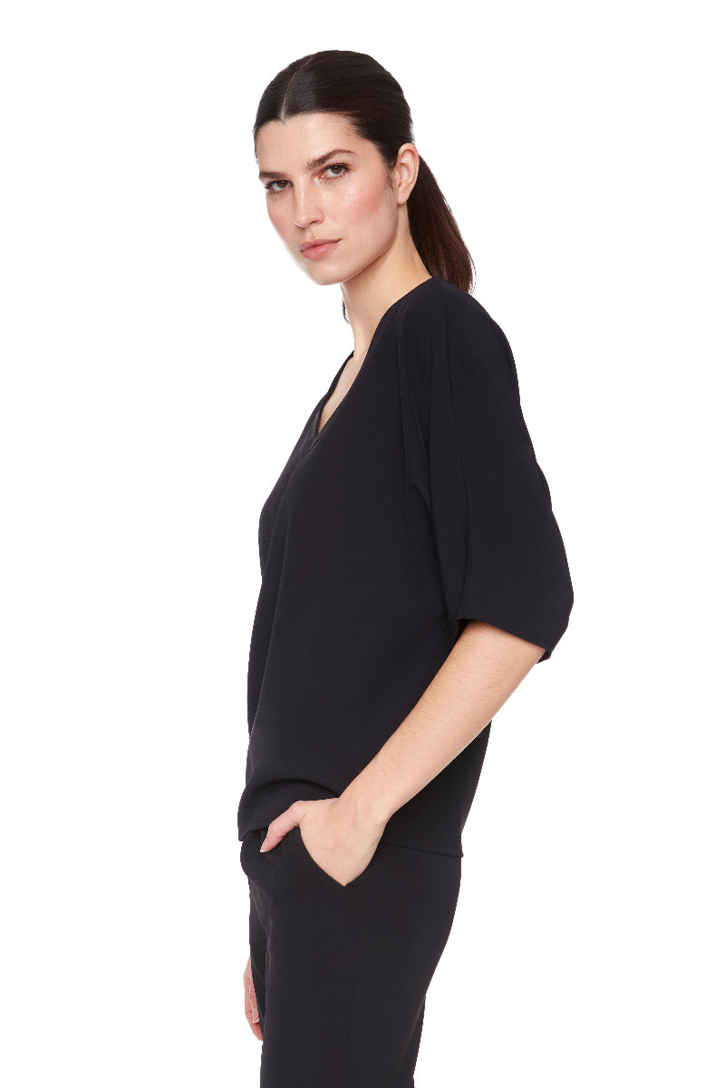 Woman wearing a black dress on a white background
