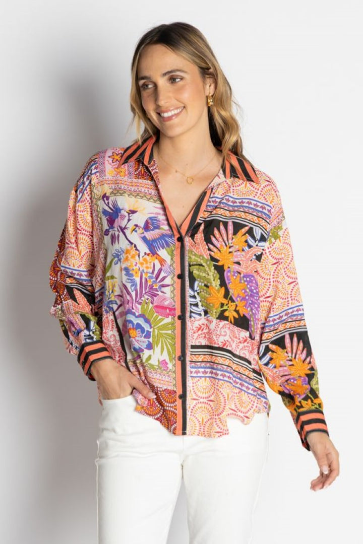 Woman wearing a colorful patterned jacket on a white background