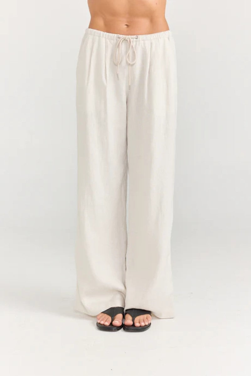 Beige wide-leg pants worn by a person on a white background