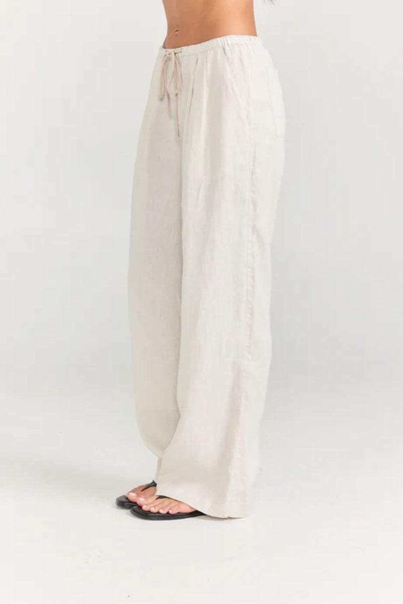 White wide-leg pants worn by a person on a white background
