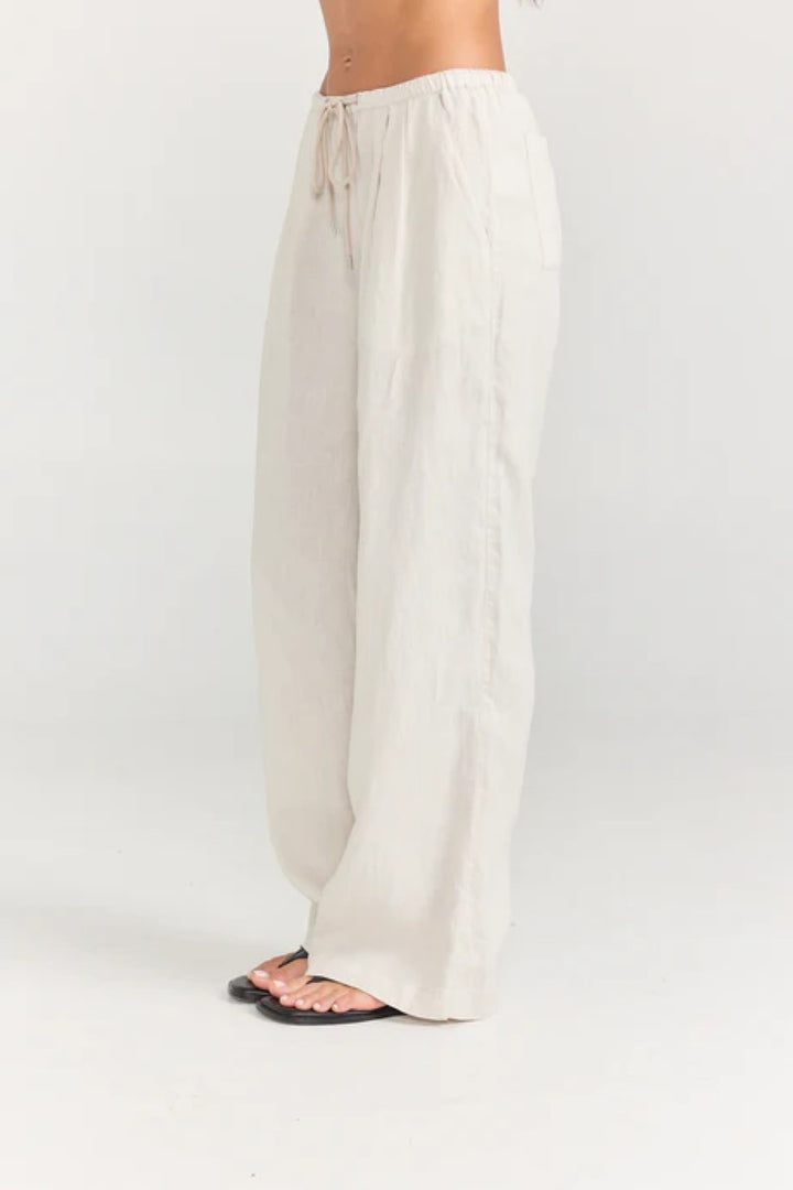 White wide-leg pants worn by a person on a white background