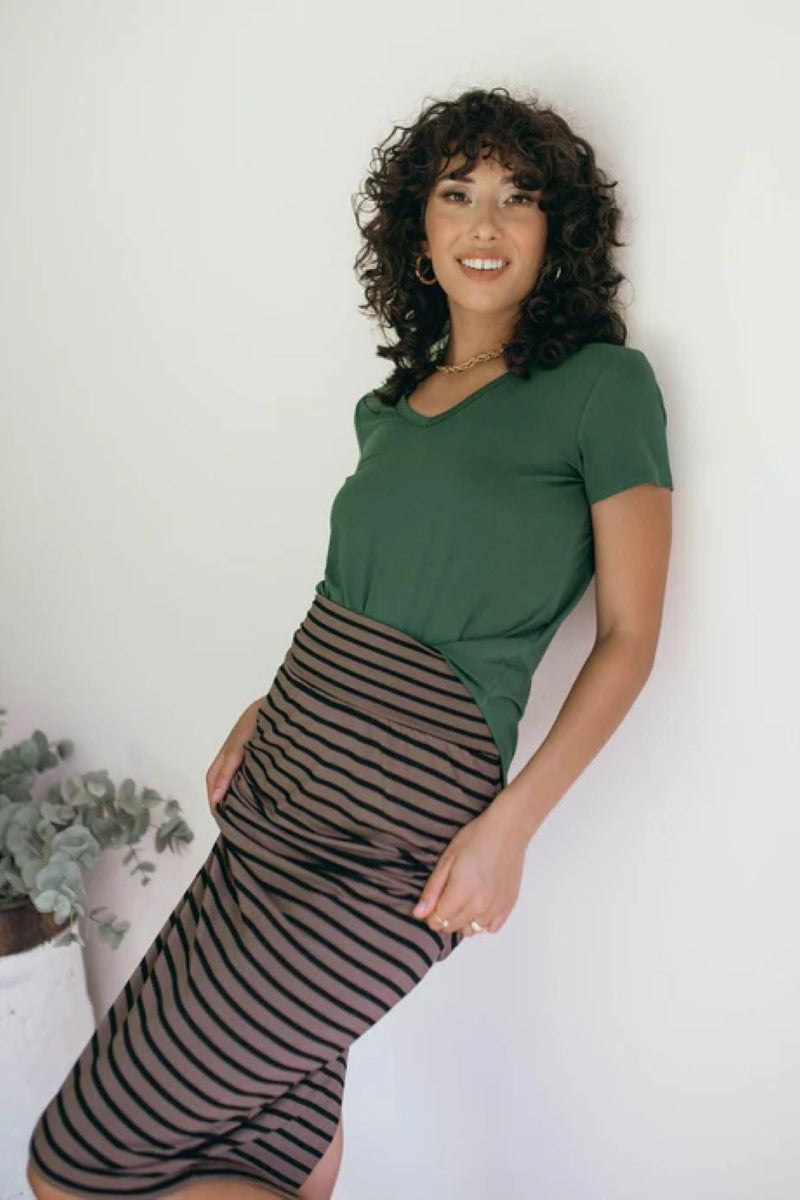 Lifestyle image of the Veronica Tee in forest green, featured at Ivy Vibe, highlighting its soft V-neckline, relaxed fit, and comfortable bamboo fabric in a casual setting.