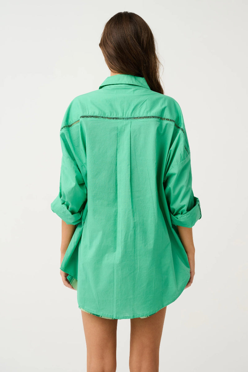 Back view of green oversized button-up shirt.