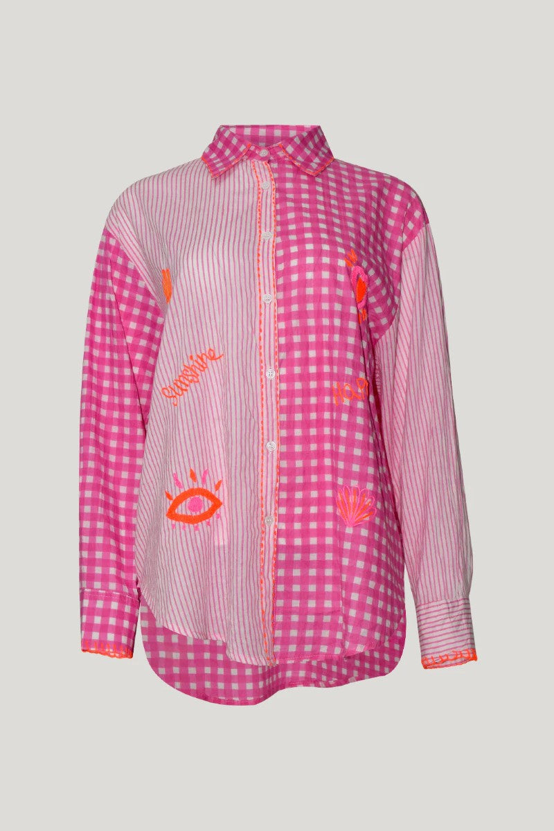 Pink checkered shirt with orange designs on a light gray background