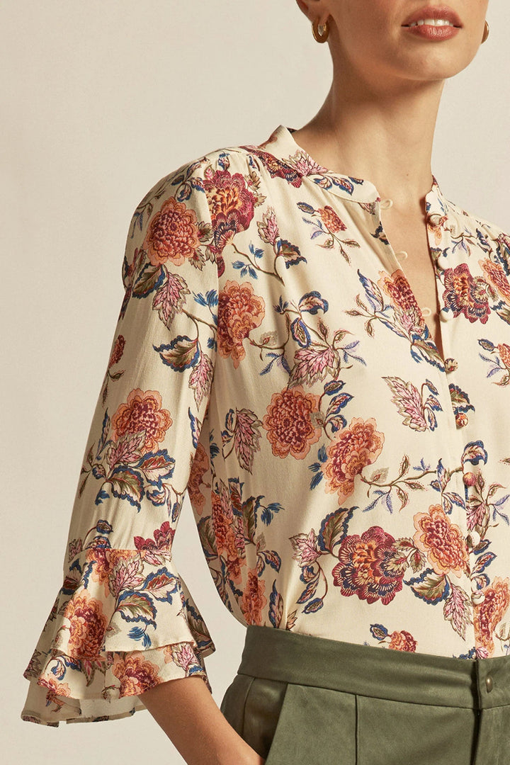 Floral blouse with long sleeves and a neutral background