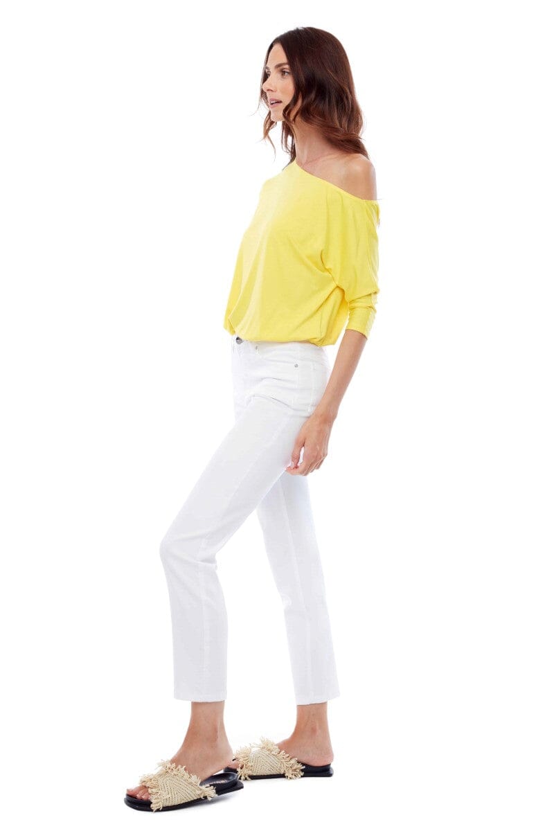 Side view of the Updated Denim Pants in white from Ivy Vibe Boutique, highlighting the sleek fit and clean modern silhouette.