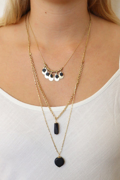 gina layered necklace on gold chains with black stones 