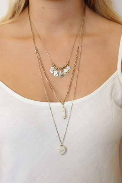 gina layered necklace on gold chains with white stones 